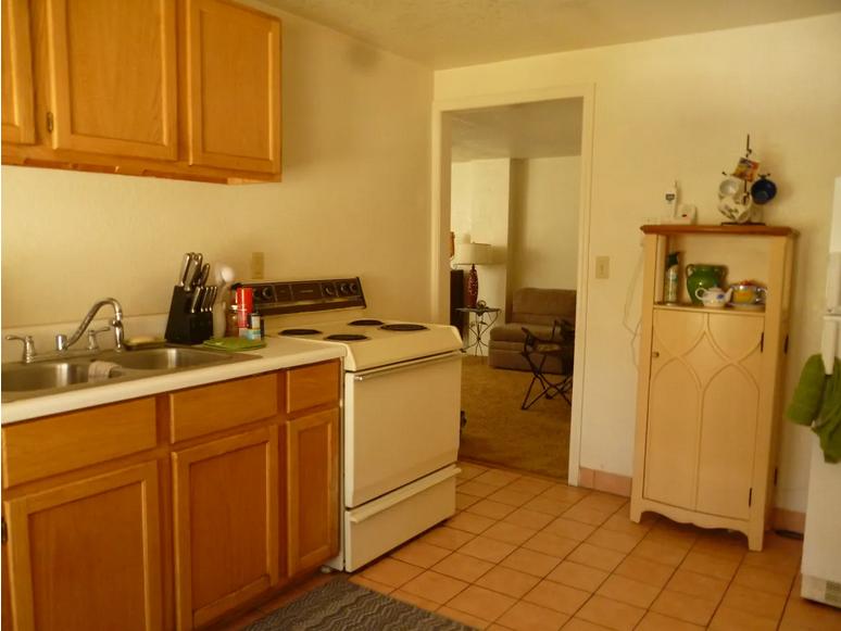 Apartment kitchen with oak cabinets and tile floor