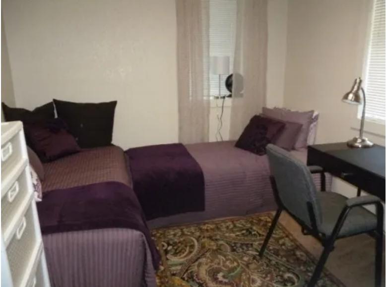 Bedroom with two beds and study desk